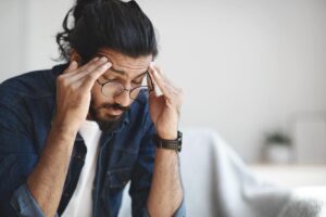 man sitting in disbelief with hands to his temples about his BAC levels