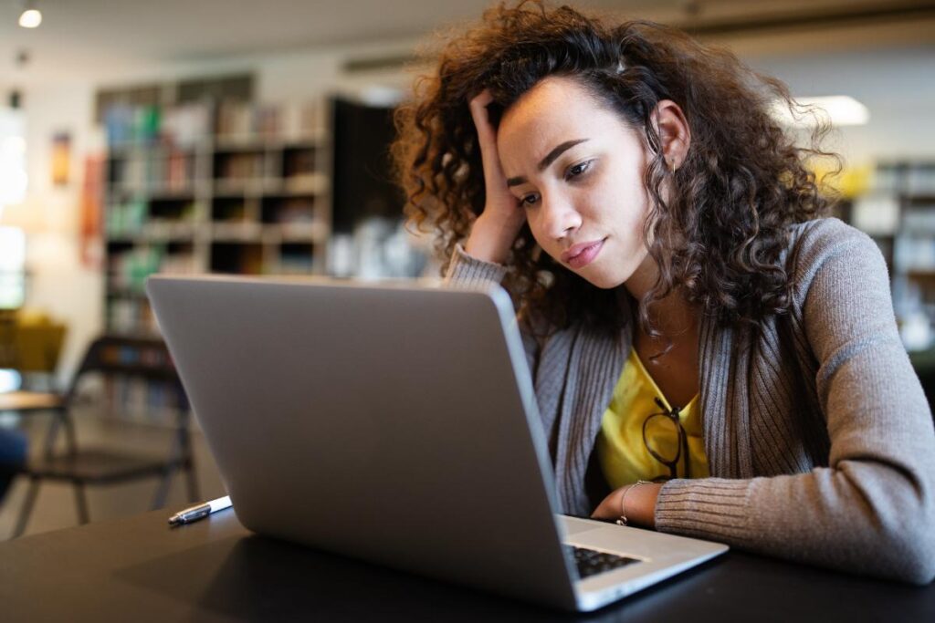 person in office trying to work on laptop while struggling with inattentive ADHD