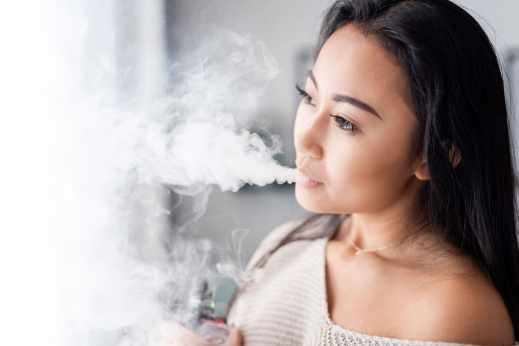 person looking out window while smoking and wondering about the connection between marijuana and memory