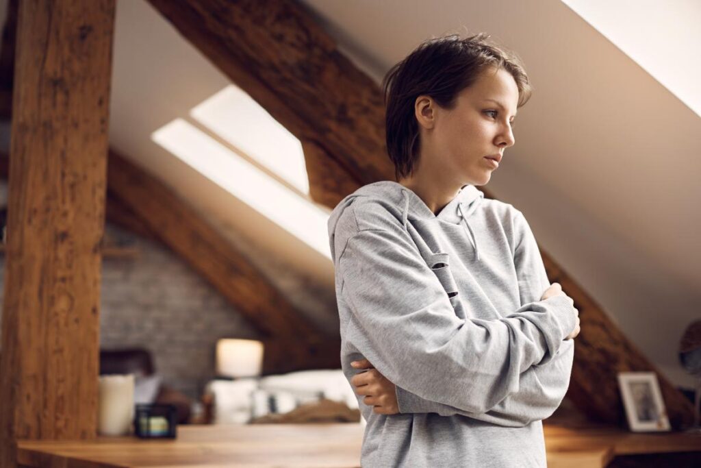 person with arms crossed with tense facial expression struggling with commonly abused opioids